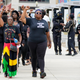 A group arrives to pay their respects at a memorial service in the Akron Civic Center for Jayland Walker in Akron, Ohio, Wednesday, July 13, 2022. On June 27, 2022 Walker was unarmed when Akron police chased him on foot and killed him in a hail of bullets, but officers believed he had shot at them earlier from a vehicle and feared he was preparing to fire again, authorities said.